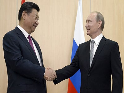 Russian President Vladimir Putin shakes hands with his Chinese counterpart Xi Jinping during their meeting in Ufa, ahead of the start of a summit of the BRICS emerging economies