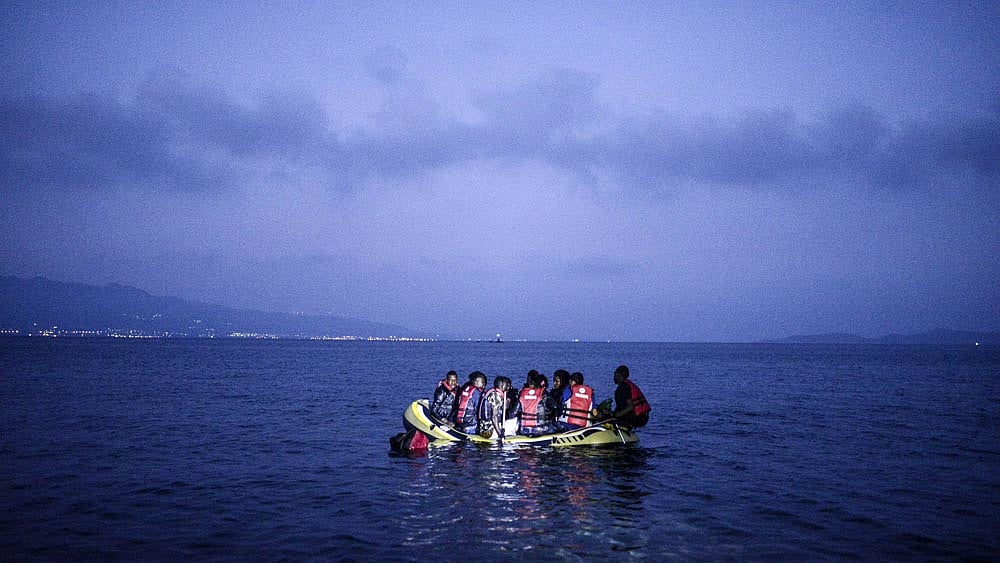 Migrants board a boat to the Greek island of Kos on early 16 August 2015 off the shore of Bodrum, southwest Turkey.
