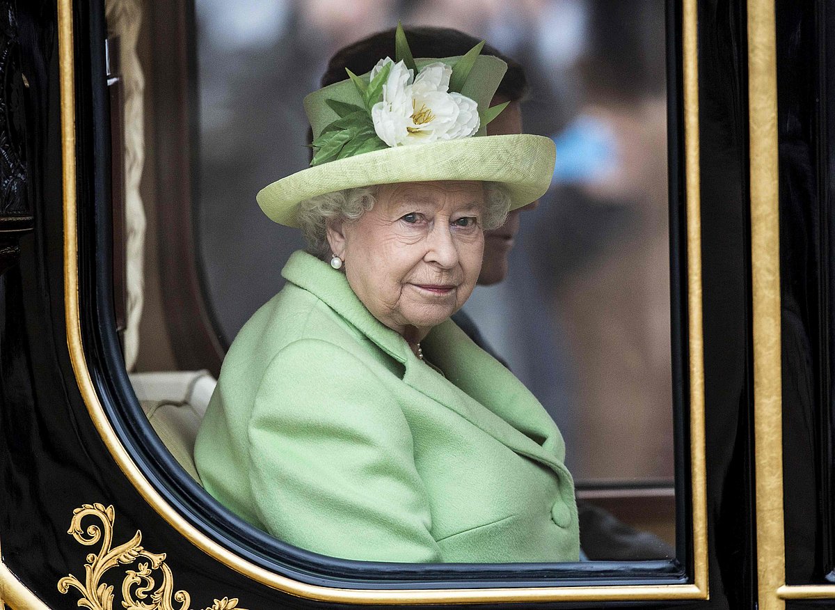 Britain`s Queen Elizabeth II looks out of the Diamond Jubilee State Coach as she travels in central London
