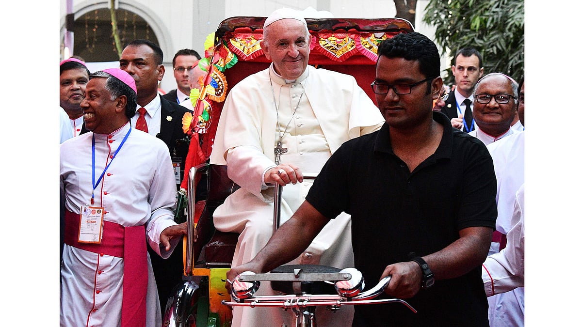 Pope Francis takes a ride in a rickshaw during the second day of his visit to Bangladesh, in Dhaka on 1 December, 2017