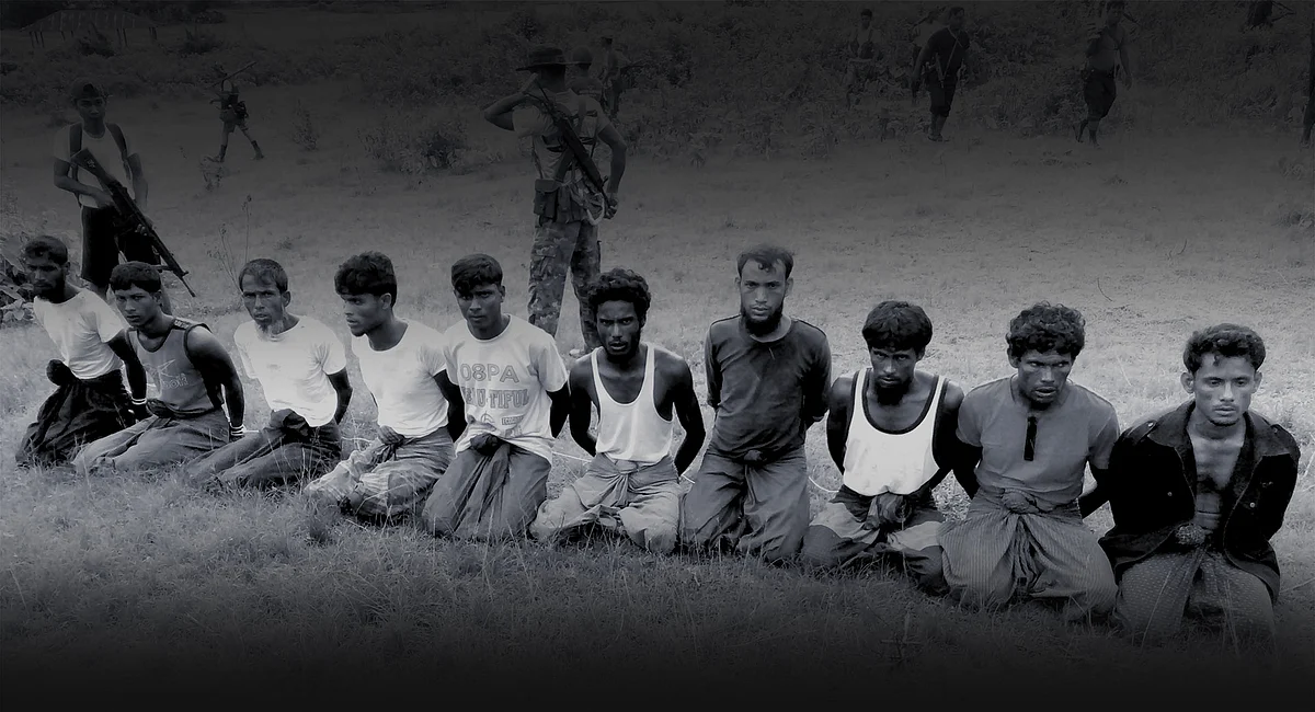This photo was taken on the day the 10 Rohingya men were killed. Paramilitary police officer Aung Min, left, stands guard behind them. The picture was obtained from a Buddhist village elder, and authenticated by witnesses. Photo: Reuters