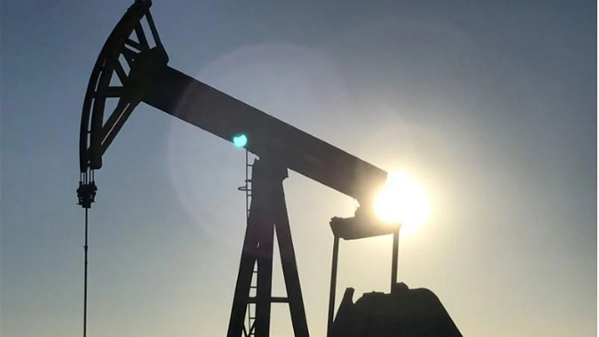 An oil pump jack is seen at sunset near Midland, Texas, US, on 3 May 2017