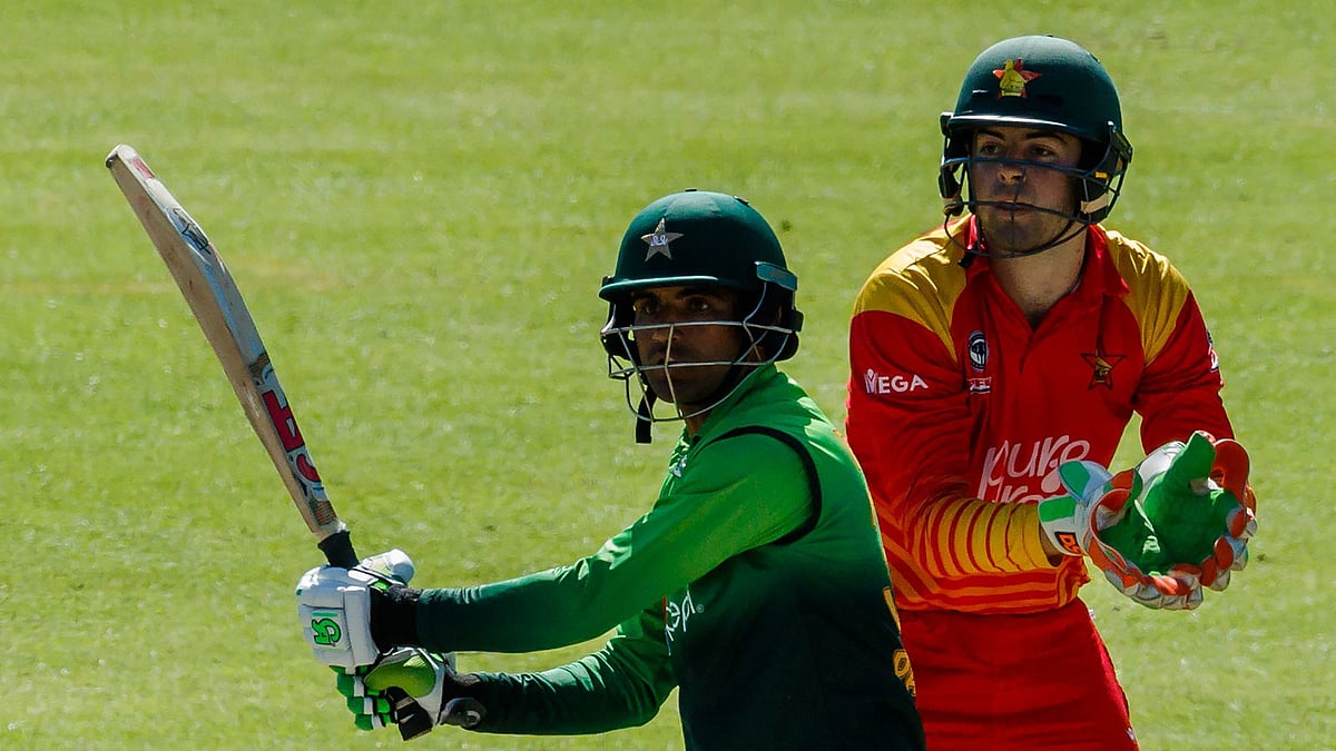 Pakistan`s batsman Fakhar Zaman (L) prepares to play a shot next to Zimbabwe`s wicket keeper Ryan Murray during the final cricket match of a five-match ODI series played between Pakistan and host Zimbabwe at Queens Sports Club in Bulawayo, on 22 July 2018.