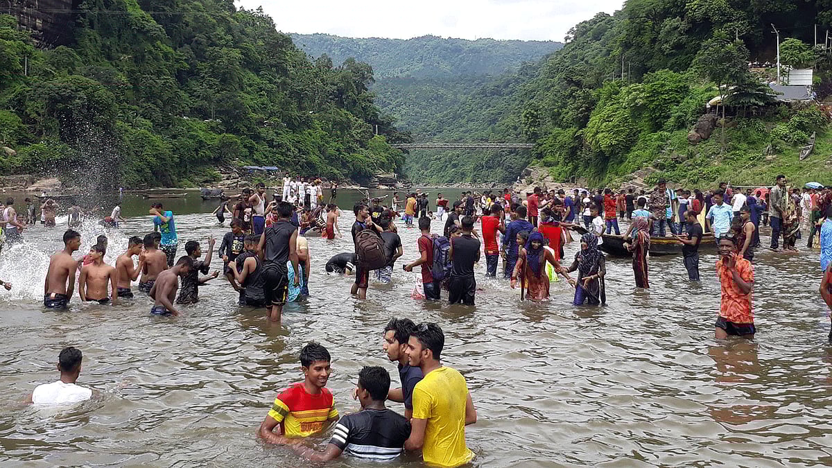Tourists play with crystal clear water of Piyain river in Sylhet's Jaflong on 23 August, 2018.