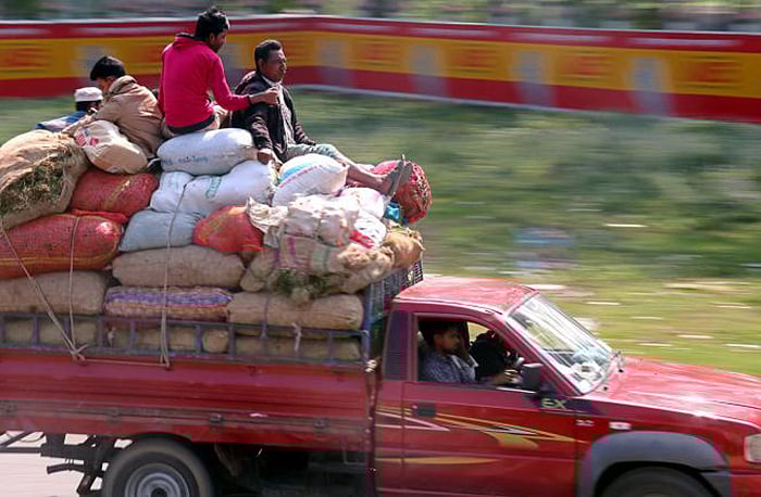 People travel on top of a goods-laden pick-up van putting their lives at risk on Dhaka-Sylhet highway in South Surma on 11 February, 2019.