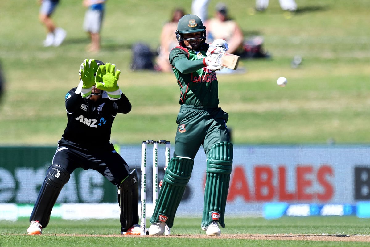 Bangladesh`s Mohammad Mithun plays a shot as New Zealand`s wicketkeeper Tom Latham (L) looks on during the first one-day international (ODI) cricket match between New Zealand and Bangladesh in Napier on 13 February 2019.