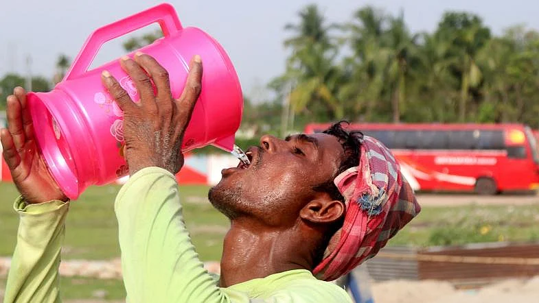 A man quenches his thirst drinking water in Nurpur, Pabna on 28 April, 2019