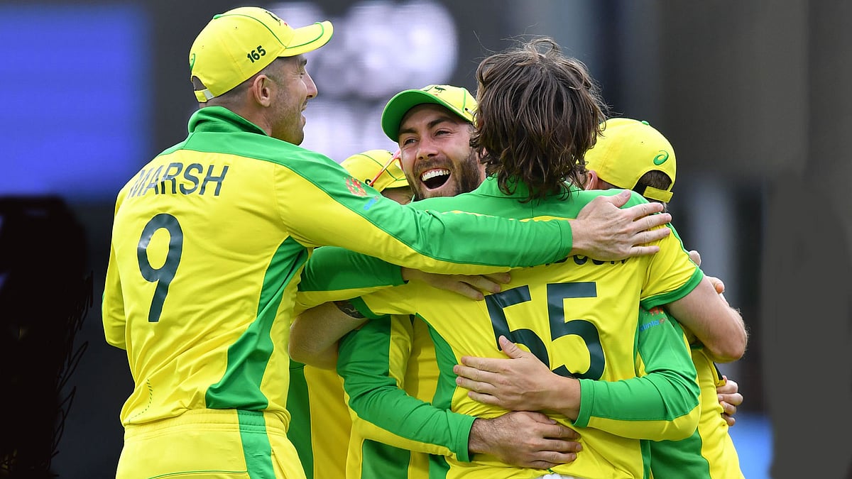 Australia`s Glenn Maxwell (C) is embraced by teammates