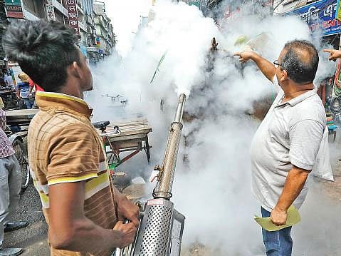 An employee isseen fogging to kill mosquitoes