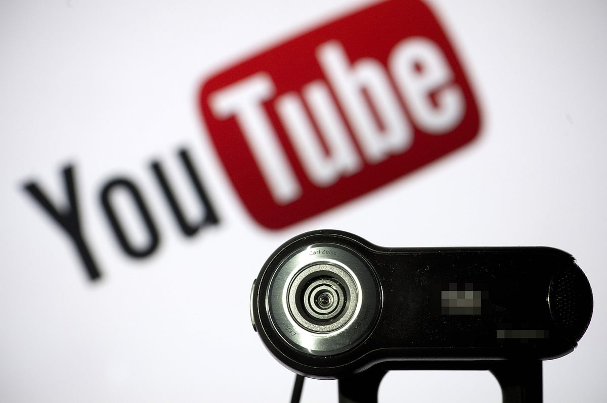 In this file photo taken on 28 June 2013 a webcam is positioned in front of YouTube`s logo in Paris.