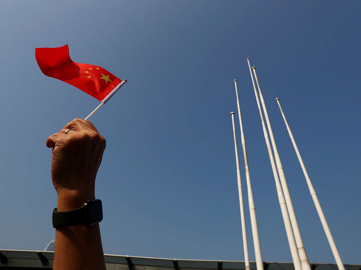 A pro-China supporter holds up a China national flag at Harbour City, during China`s National Day in Hong Kong, China on 1 October 2019