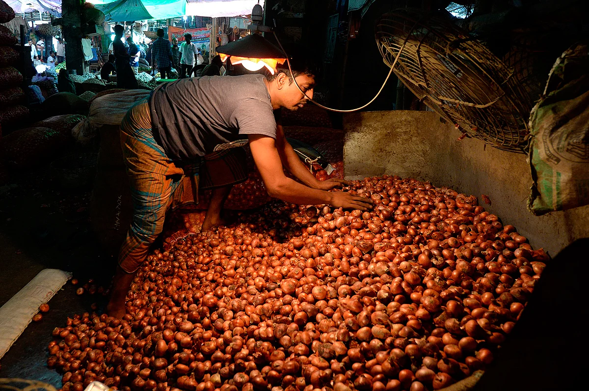 A salesman with onions at Kawran Bazar wholesale market in Dhaka on 2 October 2019.
