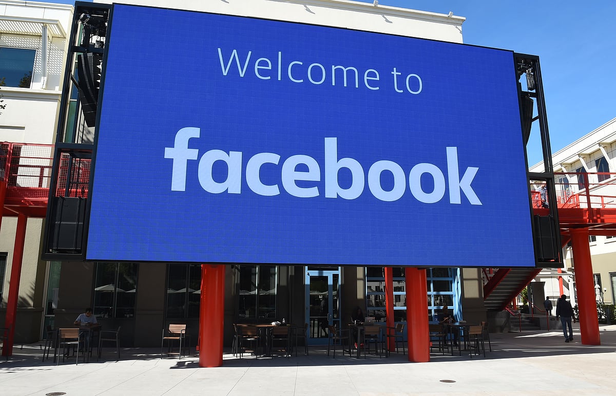 In this file photo taken on 23 October 2019 a giant digital sign is seen at Facebook`s corporate headquarters campus in Menlo Park, California. Digital services company Cognizant on 31 October 2019 said it will stop its work to help filter vile content posted at online venues such as Facebook.