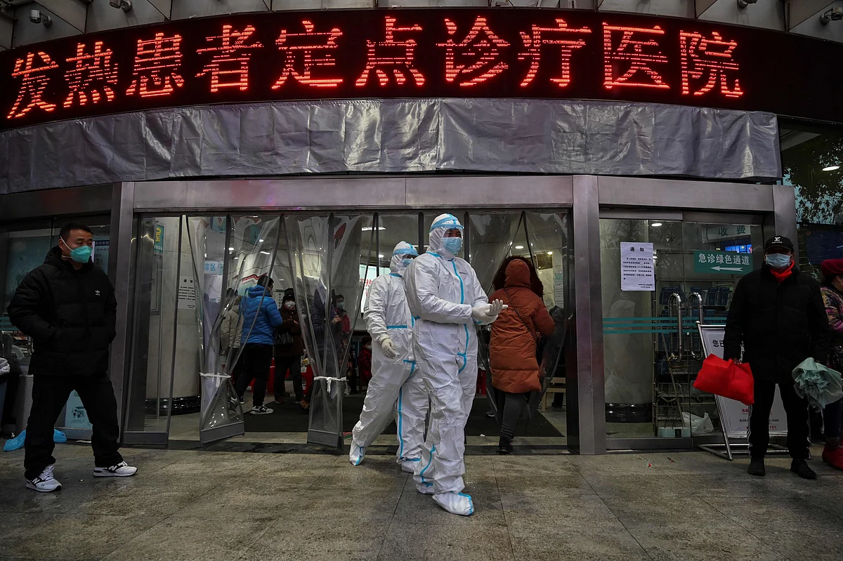 This file photo taken on 25 January, 2020 shows medical staff members wearing protective clothing to help stop the spread of a deadly virus which began in the city as they walk at the Wuhan Red Cross Hospital in Wuhan
