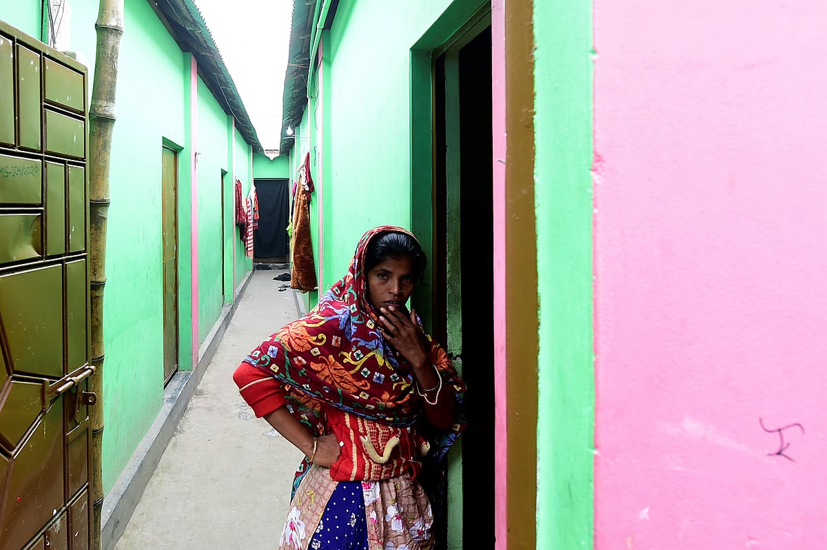 This photograph taken on 8 February shows Jhumur Begum (centre R), who heads a sex workers group, walking with members of the group through a brothel area in Daulatdia, Rajbari, 110 kms (70 miles) west of Dhaka.