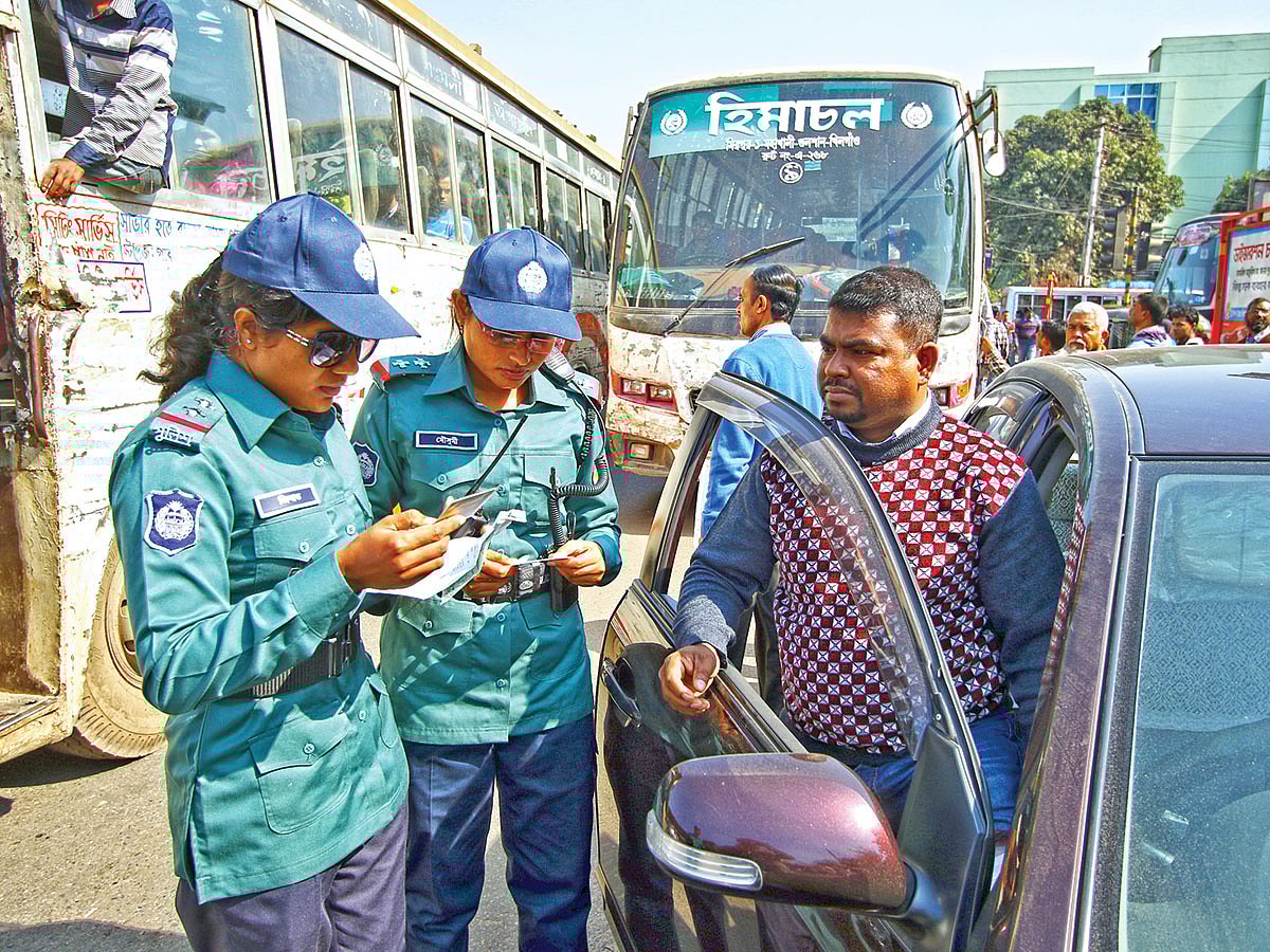 গাড়ির কাগজপত্র পরীক্ষা করছেন দুই নারী পুলিশ সার্জেন্ট। ছবিটি রাজধানীর মহাখালী এলাকা থেকে সম্প্রতি তোলা